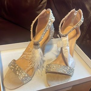 Beautiful beige heels with feather tassels, beads, and zipper back.